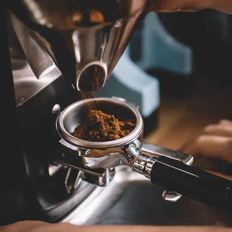 Close-up of a high-quality coffee grinder, showcasing precision grinding for optimal espresso extraction.