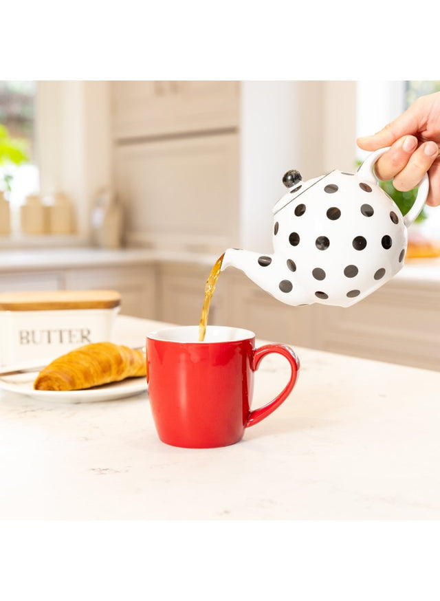 London Pottery Globe 2 Cup Teapot White With Black Spots Pouring Cup of Tea