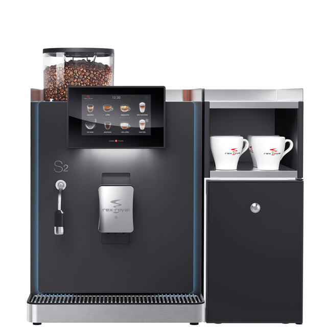 Rex-Royal S2 bean-to-cup coffee machine, designed for cafés, restaurants, and offices. Compact and Swiss-engineered, it features a 7-inch touchscreen, advanced milk system, and automated cleaning. Customisable with payment solutions and cup dispensers, delivering barista-quality coffee efficiently in high-demand environments.