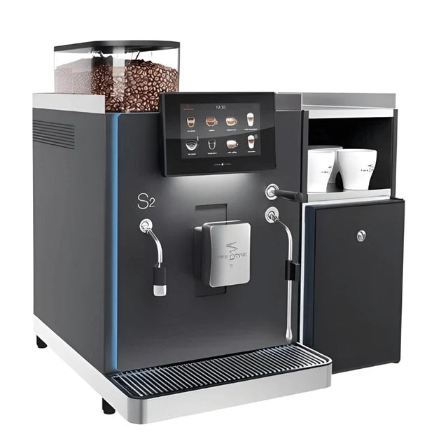 Rex-Royal S2 bean-to-cup coffee machine, designed for cafés, restaurants, and offices. Compact and Swiss-engineered, it features a 7-inch touchscreen, advanced milk system, and automated cleaning. Customisable with payment solutions and cup dispensers, delivering barista-quality coffee efficiently in high-demand environments.