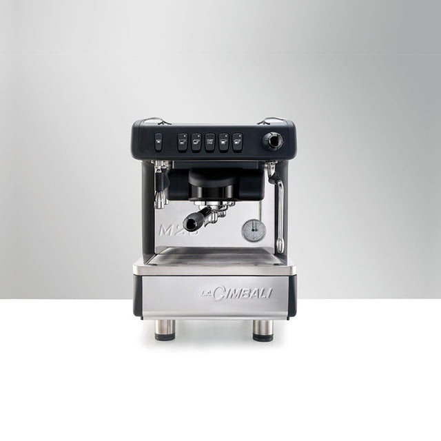 La Cimbali M26 SE espresso machine, ideal for cafés and restaurants. Features Italian craftsmanship, ThermoDrive Technology for consistent temperature control, and energy-saving mode. Available in sleek black and white finishes for reliable, barista-quality coffee service.