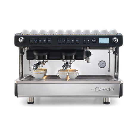 La Cimbali M26 SE espresso machine, ideal for cafés and restaurants. Features Italian craftsmanship, ThermoDrive Technology for consistent temperature control, and energy-saving mode. Available in sleek black and white finishes for reliable, barista-quality coffee service.